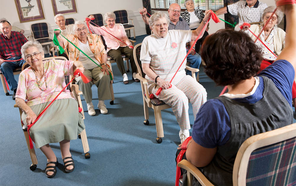 Seniors exercising with resistance bands in group class
