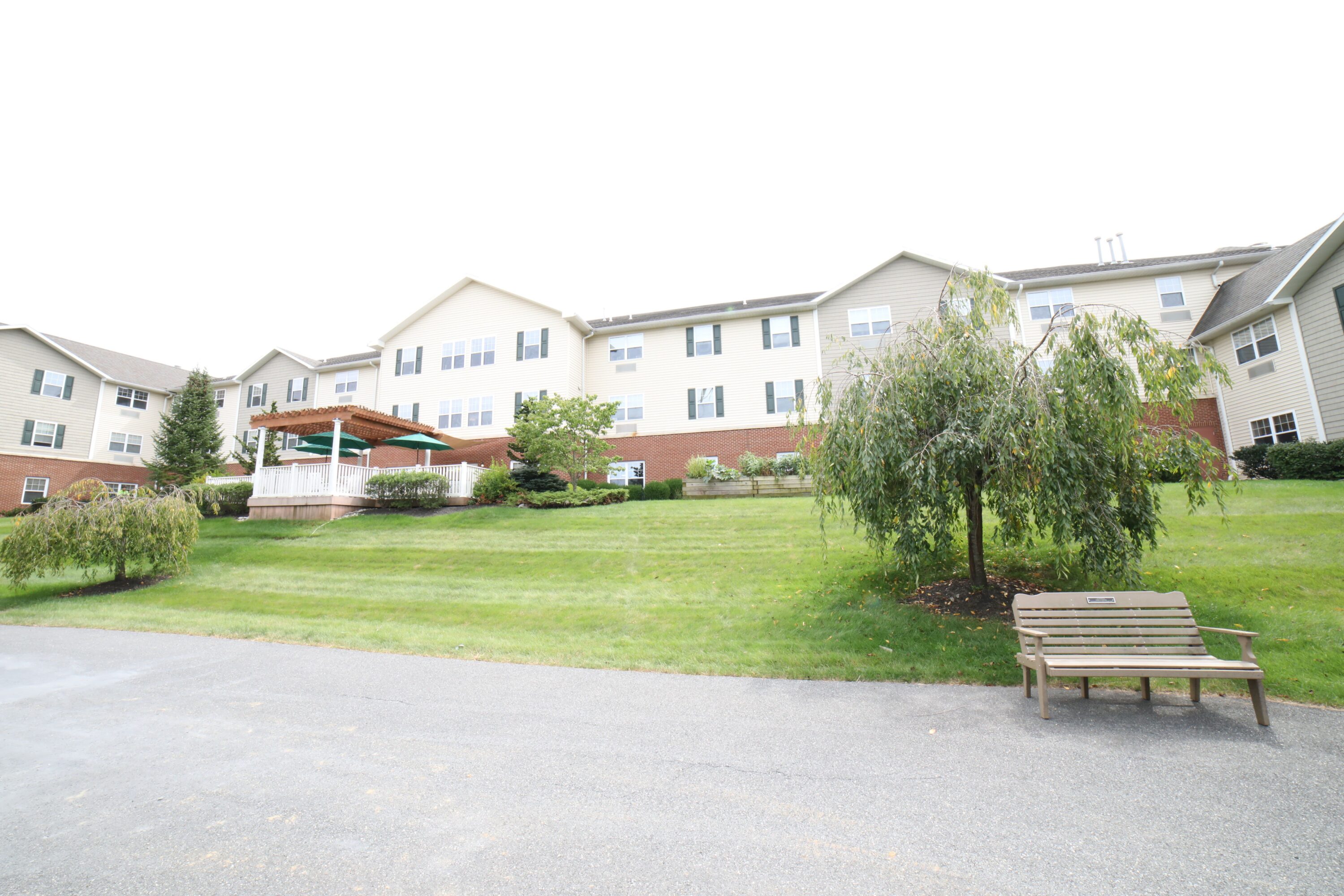 Apartment building with gazebo and landscaped lawn