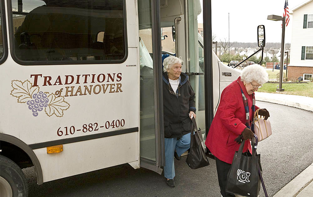 Elderly women exiting community shuttle bus