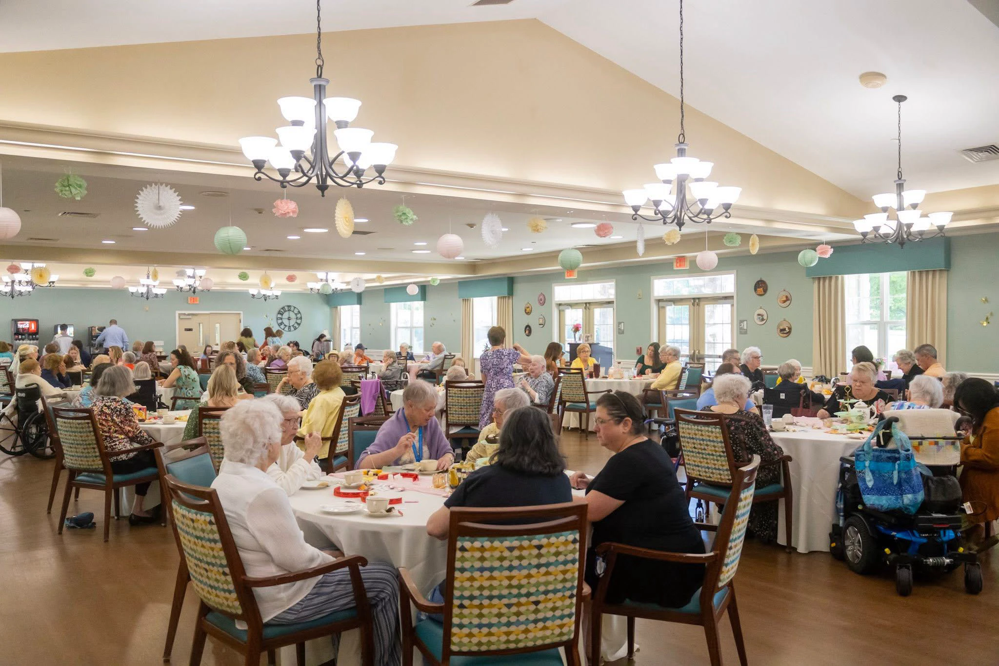 Seniors gather for a decorated dining room social event.